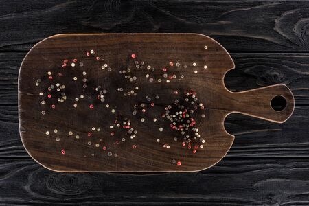top view of wooden cutting board with spices on tableの写真素材