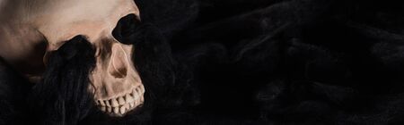 panoramic shot of spooky human skull with black dark clouds, Halloween decoration