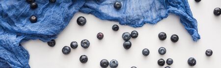 panoramic shot of fresh and ripe blueberries with blue clothの写真素材