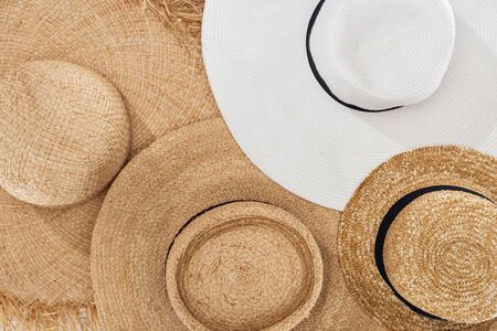 pile of summer beige and white straw hats