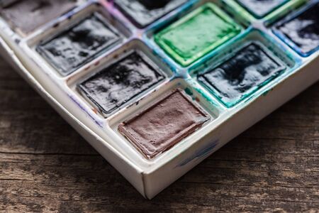 close up view of watercolor dirty colorful paint paletteの写真素材