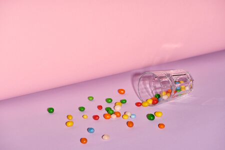 glass with sweet candies on bright and colorful backgroundの写真素材