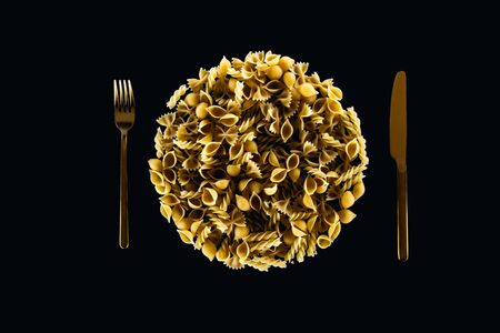 top view of plate concept with metal fork and knife isolated on blackの写真素材