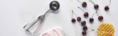top view delicious ice cream with cherries, ice cream spoon and waffles on marble grey background, panoramic shotの写真素材