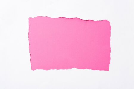 pink colorful background in white torn paper holeの写真素材