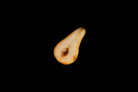 top view of ripe pear half isolated on blackの写真素材