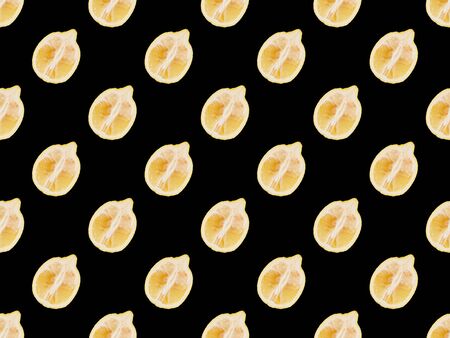 background pattern with cut lemons isolated on blackの写真素材