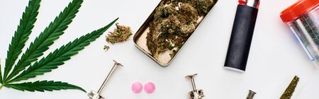 top view of marijuana buds, cannabis leaf, pills and syringes on white background, panoramic shotの写真素材