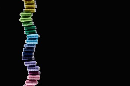 top view of bright and colorful threads isolated on black