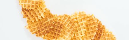 panoramic shot of crispy waffles on white