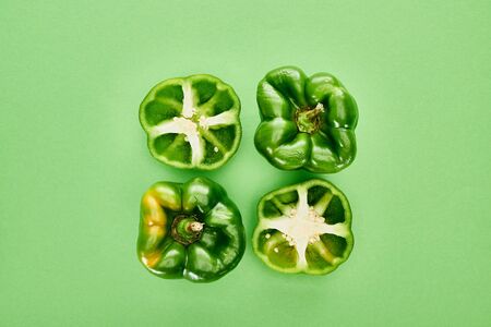 top view of fresh and organic peppers on green backgroundの写真素材