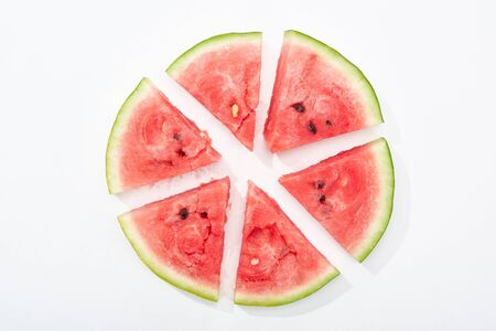 top view of round cut juicy watermelon on white backgroundの写真素材