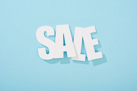 top view of white sale lettering on blue background