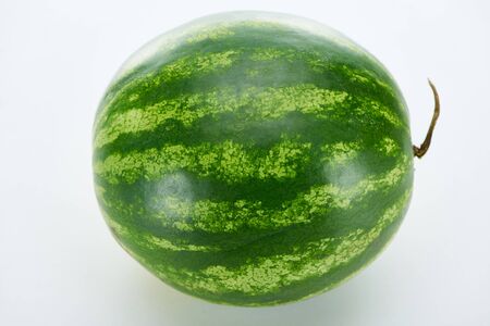 whole ripe green watermelon on white backgroundの写真素材