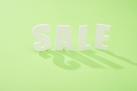 white sale lettering with shadow on green background