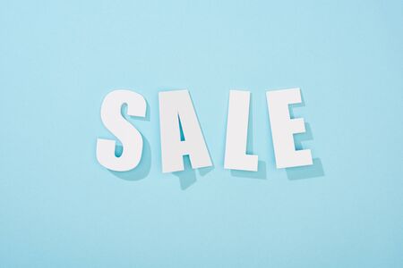 top view of white sale lettering on light blue backgroundの写真素材