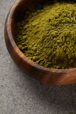 close up view of green matcha powder in wooden bowlの写真素材
