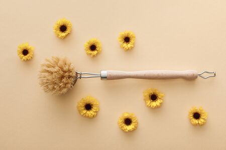 top view of body brush on beige background with flowersの写真素材