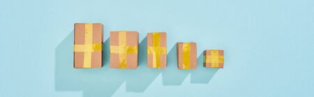 panoramic shot of closed postal boxes on blue background with copy space