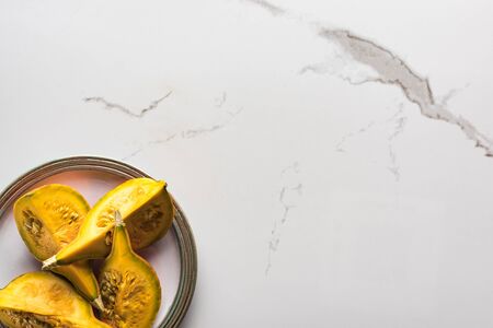 top view of marble surface with plate with pumpkinの写真素材
