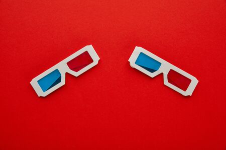 top view of 3d glasses on red backgroundの写真素材