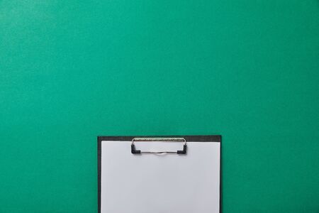 top view of folder with blank paper isolated on green isolated on greenの写真素材