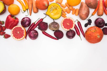top view of assorted autumn vegetables, citruses, fruits and berries on white background