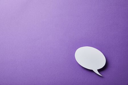 white speech bubble card on purple surfaceの写真素材