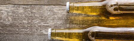 top view of beer in bottles on wooden background, panoramic shotの写真素材