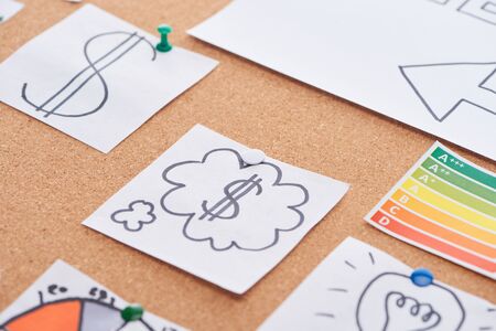 paper cards with dollar signs pinned on cork office boardの写真素材
