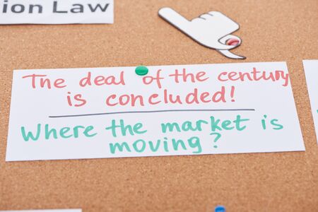 paper card with work notes and paper craft hand pointing with finger pinned on cork office boardの写真素材