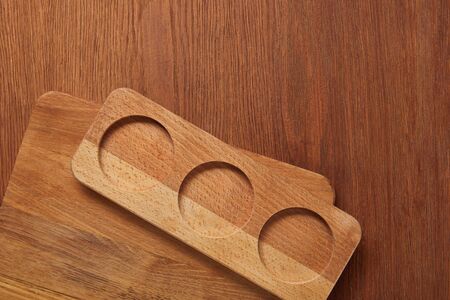 top view of board with circles near chopping board on wooden table