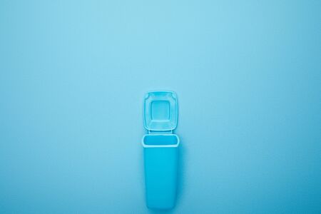 top view of open blue recycle bin on blue background