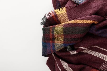 top view of burgundy wool plaid scarf on white background