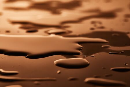 water puddles and drops on brown backgroundの写真素材