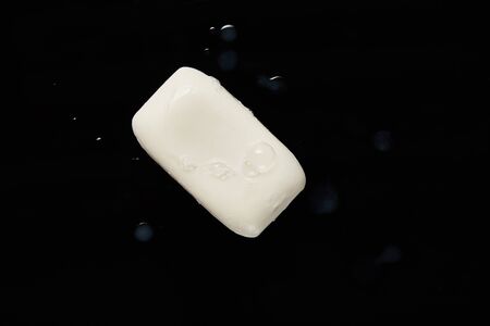 top view of white soap with drops on black backgroundの写真素材