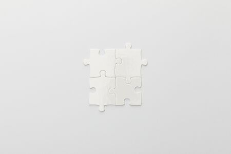top view of completed part of jigsaw puzzle on white backgroundの写真素材