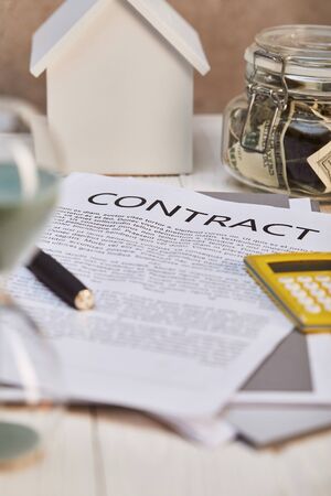 selective focus of house model , contract and moneybox, real estate conceptの写真素材