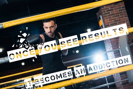 selective focus of strong man in boxing gloves working out in gym with once you see results, it...