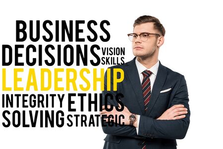 handsome businessman standing with crossed arms near business decisions vision skills leadership integrity ethics solving strategic lettering on whiteの写真素材