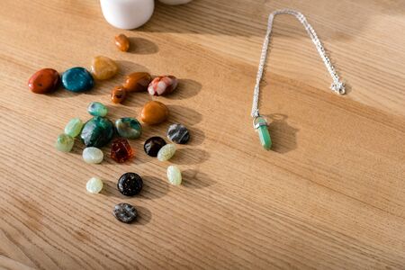 bright colorful semiprecious stones on brown wooden surface