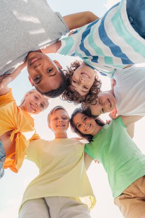 bottom view of positive multicultural kids looking at cameraの写真素材
