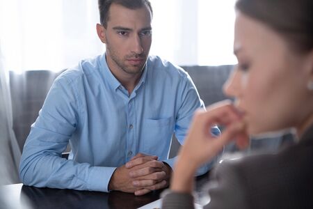 selective focus of woman and serious man with clenched hands
