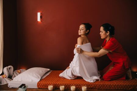 asian woman wrapping with towel attractive woman in spa salonの写真素材