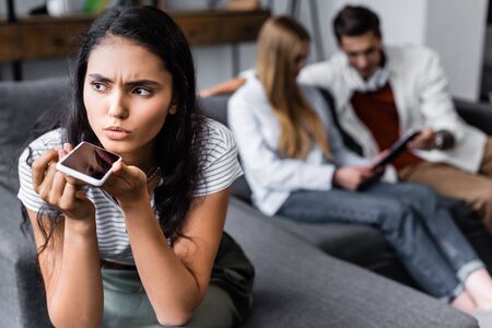 selective focus of bi-racial woman talking on smartphone in apartmentの写真素材