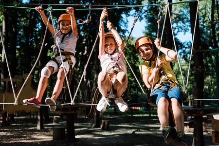 happy multicultural kids in high rope trail outsideの写真素材