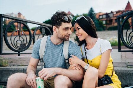 asian woman and handsome man hugging and looking at each otherの写真素材
