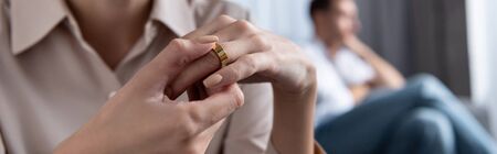 panoramic shot of woman in shirt taking off ring at homeの写真素材
