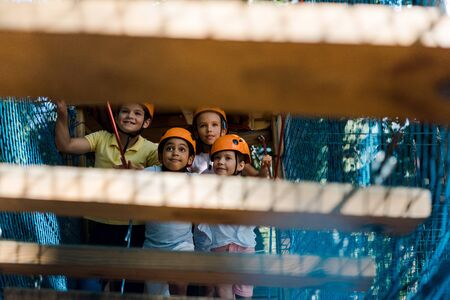 selective focus of happy multiethnic kids near high rope trailの写真素材