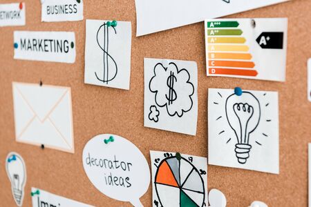 selective focus of papers with lettering near charts and graphs on notice boardの写真素材